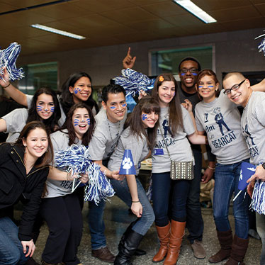 Group of people with streamers and face paint smiling. Read about Gifts That Pay You Income