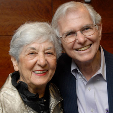Couple smiling together at camera. Read about Gifts That Protect Your Assets