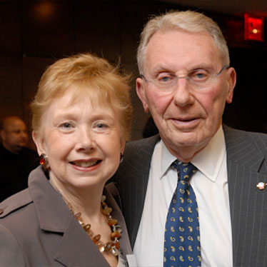 Couple standing together smiling. Read about Gifts of Real Estate